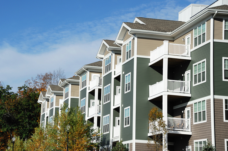 apartment building with autumn trees landscape
